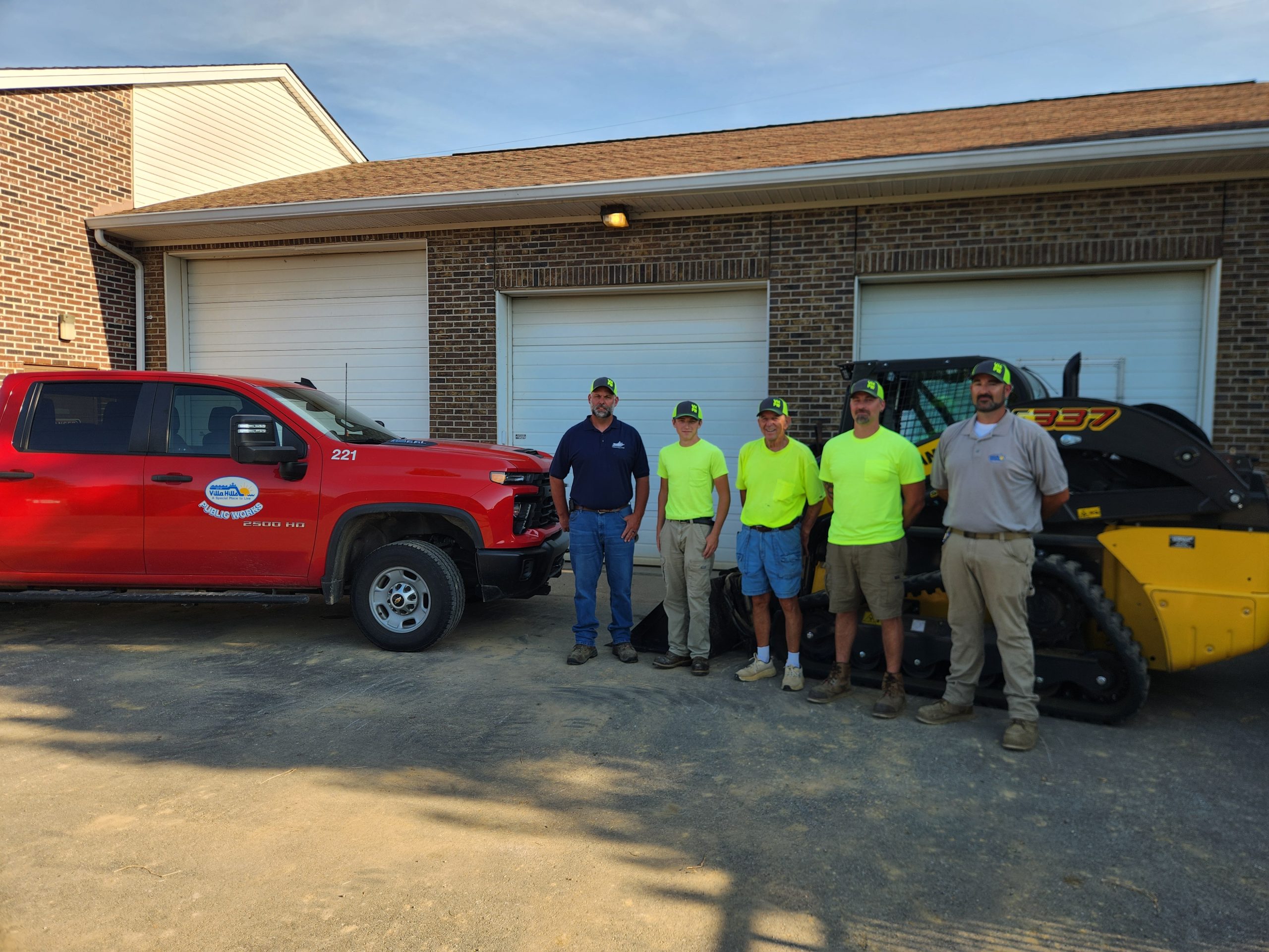 Public Works crew in front of garage